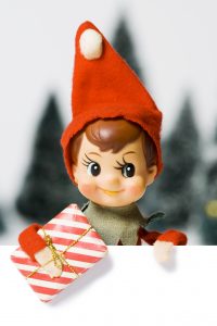Elf wearing red hat with present